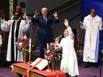 President Biden raises his arms in praise during a service at Mount Airy Church of God in Christ in Philadelphia on July 7, 2024.