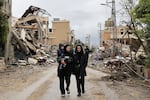 Residents walk amid the destruction in the southern Lebanese village of Zibqin on November 27, 2024, as people who had fled the war between Israel and Hezbollah returned to check on their homes after a ceasefire between the warring sides took effect.