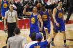Golden State Warriors guard Steph Curry, 30, celebrates with teammates Draymond Green, 23, and Klay Thompson after hitting a 3-pointer. The Warriors defeated the Portland Trail Blazers 132-125 in Game 4 of the Western Conference Semifinals on Monday, May 9, 2016.