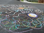 A freshly painted street mural outside Liuzza's by the Track in New Orleans on Tuesday, April 26, 2022, celebrates the impending return of the New Orleans Jazz and Heritage Festival.