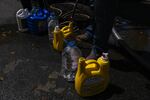 Residents of Orocovis line up at the Coliseum Jesus "Tito" Colón to fill gallons, cisterns, and any kind of container with water.