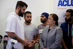 Karandeep Singh, who is seeking asylum from political persecution in India, speaks with an interpreter at a press conference Aug. 22, 2018.