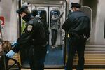 Bires (left) assists a woman onto the train at the 11th Street stop on the Market-Frankford Line.