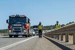 In this photo provided by the Department of Fire and Emergency Services, its members search for a radioactive capsule believed to have fallen off a truck being transported on a freight route on the outskirts of Perth, Australia, on Saturday.