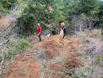 A provided photo of University of Oregon students Logan Wetherel and Brooke Hunter researching a landslide along the Oregon Coast in 2021.