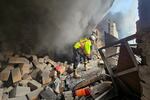 A first responder looks for survivors at the scene of an Israeli airstrike that targeted a building in a southern suburb of Beirut on Tuesday.