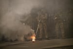 Federal law enforcement officers fire impact munitions and tear gas at protesters demonstrating against racism and police violence in front of the Mark O. Hatfield federal courthouse in Portland, Ore., on July 16, 2020.