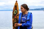 JJ Lowley, Coeur d’Alene Tribe, Colville Tribes and Nimmiipuu, a 19-year-old member of the Portland All Nations Canoe Family, holds her paddle on the shore of Owen Beach on July 30, 2024, the second to last day of the 2024 Canoe Journey. This year, she guided her canoe family as skipper.