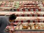 A man shops for meat at a grocery store in Annapolis, Md., on May 16 as Americans brace for summer sticker shock because of high inflation.