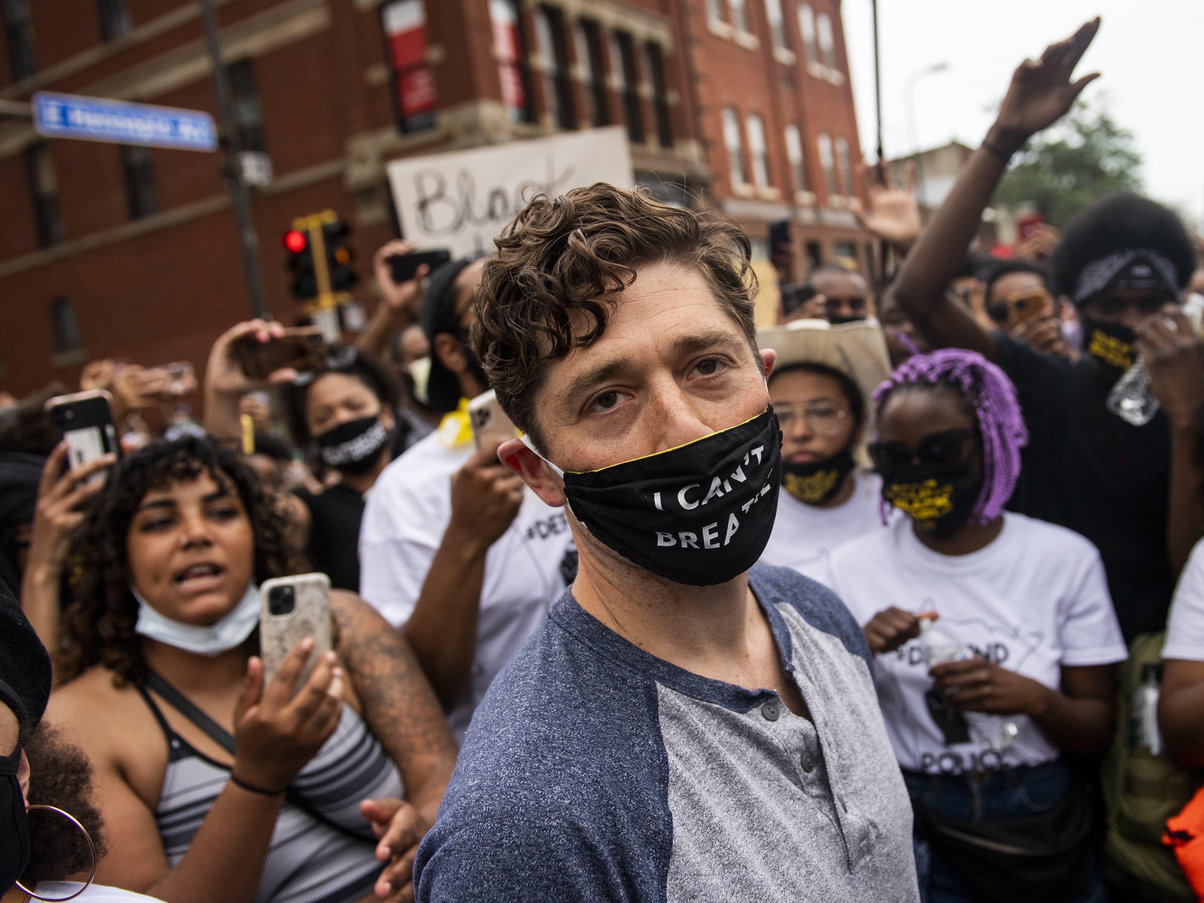 Minneapolis Mayor Jacob Frey leaves after speaking Saturday to demonstrators calling for the Minneapolis Police Department to be defunded. When asked whether he would agree to defund the police, Frey said no, and was then asked to leave the protest.