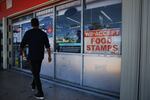 A 'We Accept Food Stamps' sign hangs in the window of a grocery store in Miami. 