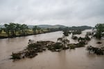 Trees emerge from flood waters along the Guadalupe River on Friday in Kerrville, Texas. Heavy rainfall caused flooding along the Guadalupe River in central Texas with dozens of fatalities reported.