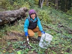 Sima Seumalo pictured in a wooded area, smiling wearing a blue shirt and and smiling.
