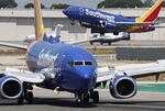 A Southwest Airlines plane takes off as another Southwest jet taxis in Burbank, Calif. Southwest Airlines has announced it will discontinue its 50-year policy of open seating, instead opting for assigned seating that will include premium seating in an effort to broaden its appeal.