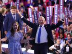 Democratic vice presidential nominee Minnesota Gov. Tim Walz reacts with his daughter Hope Walz after accepting the Democratic vice presidential nomination on stage during the third day of the Democratic National Convention.