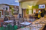 People seen through a window inside a bar in La Cabrera, on the outskirts of Madrid, Spain, watch a televised speech by Spanish Prime Minister Pedro Sanchez from La Moncloa Palace announcing national elections, Monday, Oct. 5, 2026.