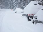 Cars on a residential street in Bend were socked in by snow on February 25, 2019. 