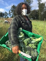 Shantae Johnson of Mudbone Grown with a harvest of fresh broccoli