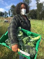 Shantae Johnson of Mudbone Grown with a harvest of fresh broccoli