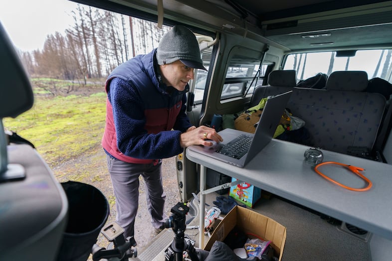 Ralph Bloemers consults a map where he is about to fly his drone to photograph a heavily burned area in the Santiam Forest, Feb. 26, 2021. He will compare the images to those he shot previously to see how the area is recovering.