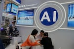 FILE -Vendors for AI enabled robots wait for customers at the 137th Canton Fair in Guangzhou in southern China's Guangdong province on April 16, 2025.