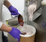 Oregon strawberry jam is layered into freshly churned strawberry ice cream to create the iconic Salt & Straw strawberry balsamic ice cream flavor at the Salt & Straw Production Facility in Portland, Ore., Aug. 8, 2022. 