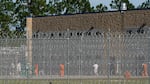 Detainees are seen in a yard at the Folkston ICE Processing Center on Sept. 9, 2025, in Folkston, Georgia. The state's two Democratic senators are demanding answers from the Department of Homeland Security after more than a dozen people have died in immigration detention facilities.
