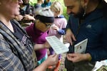 Volunteers examine multiple species of aquatic insects found near Kellogg Creek on May 18, 2024. Using a field guide, they logged each bug into a log for the 2024 BioBlitz.