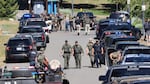 Law enforcement and emergency responders are shown on Sunday afternoon following reports of an ambush shooting attack on Canfield Mountain, in Coeur d'Alene, Idaho.