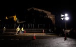 Crews install metal plates to help protect the street from tank damage for the upcoming military parade on June 10 in Washington, D.C.