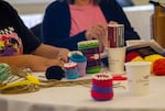At one station, participants learned how to weave wool baskets, using multi-colored strands of yarn, creating patterns.
