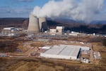 A data center owned by Amazon Web Services, front right, is under construction next to the Susquehanna nuclear power plant in Berwick, Pa. Tech companies like Amazon and Google are investing in nuclear to power their next generation of data centers.