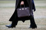 Former first lady Melania Trump is seen toting a Hermes handbag while walking across the South Lawn of the White House in 2019.