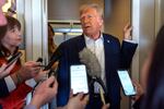 President Donald Trump speaks to reporters aboard Air Force One as he travels from Las Vegas to Miami, on Saturday.