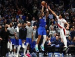 Dallas Mavericks forward P.J. Washington (25) shoots the go-ahead three-pointer against Portland Trail Blazers guard Shaedon Sharpe (17) in the fourth quarter in an NBA basketball game Thursday, Jan. 9, 2025, in Dallas.