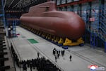 In this undated photo provided Thursday, Dec. 25, 2025, by the North Korean government, its leader Kim Jong Un inspects a nuclear-powered submarine under construction at an undisclosed location in North Korea. Independent journalists were not given access to cover the event depicted in this image distributed by the North Korean government. The content of this image is as provided and cannot be independently verified. Korean language watermark on image as provided by source reads: "KCNA" which is the abbreviation for Korean Central News Agency.