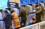 FILE: Voters at the Multnomah County Elections Division in Portland, Ore., Nov. 8, 2022. A bill before the Oregon Senate would expand the state's automatic voter registration system. 