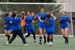 FILE - Aubrey Decraig, third from right, celebrates with teammates after scoring a goal during a soccer tournament for immigrant and refugee girls on Sunday, March 29, 2026, in Portland, Ore.