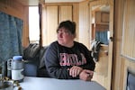 Rancher Kim Kerns sits in the trailer she uses when looking after her sheep up in the hills.