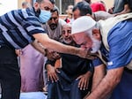 People mourn as they collect the bodies of Palestinians killed in Israeli air raids on Nov. 5, 2023 in Khan Yunis, Gaza.