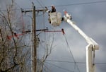 PGE contractors from DJ's Electrical in Portland repair a transformer box on a power pole on Southeast Madison Street near Southeast 17th Avenue in Portland, Feb. 16, 2021.