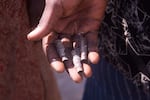 Terhemba Iormba holds bullet casings covered in ash. His family members were killed during an attack in Yelwata Village, central Nigeria in mid-June.