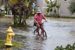 A resident rides a bicycle through floodwaters from Hurricane Idalia in Gulfport, Florida, US, on Wednesday, Aug. 30, 2023.