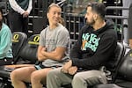 New York Liberty guard Sabrina Ionescu, left, talks with assistant coach Zach O'Brien, right, before a preseason WNBA basketball game against the Toyota Antelopes, of Japan, in Eugene, Oregon, Monday, May 12, 2025.