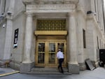 A man enters the New York Stock Exchange on Wall Street in New York City on Friday.
