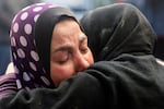 Women react upon identifying the body of a relative killed in an Israeli bombardment at Rafah's Najjar hospital on Saturday, Feb. 3.