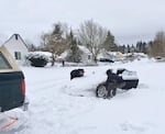 Sam Piva (in the navy bill cap with gold letters) drove his Honda S2000 up from Eugene Tuesday night, encountering little trouble on I-5 or I-205, and was a half block from his home when it got stuck in the snow-filled streets at the western base of Rocky Butte around 10:30 p.m. On Wednesday morning, carpenter Tracy Terry pitched in and tried to pull Piva's car out of the drift by hooking it to his truck but they couldn't dig it free and had to abandon it. Piva is a recent University of Oregon graduate who just started work as a graphic designer at the Hive agency on the inner East Side.
