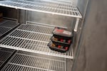 Three packages of ground beef remain on one side of a fridge at the Dallas Food Bank in Dallas, Ore., on July 30, 2026. Volunteers say this fridge would normally be full of meat.