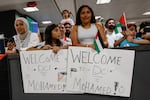 A group of people gather to greet two severely wounded Palestinian teenagers from Gaza arriving at Dulles International Airport near Washington for urgent medical treatment on Aug. 9, 2025.