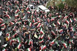 A group of demonstrators wave Iranian flags in support of the government and against U.S. and Israeli strikes in Tehran, Iran, Saturday, Feb. 28, 2026.